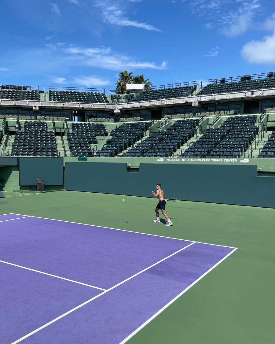 A player training on an empty stadium court